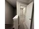 Open attic access showing storage space with shelving, illuminated by a light at 12032 Lavinia Ln, Charlotte, NC 28277