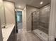 Modern bathroom with a single vanity, shower and grey tile at 12032 Lavinia Ln, Charlotte, NC 28277