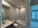 Bathroom featuring a tub with marble tile and single vanity with modern fixtures at 12032 Lavinia Ln, Charlotte, NC 28277