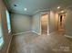 Neutral bedroom features carpet flooring, a walk-in closet, and windows for natural light at 12032 Lavinia Ln, Charlotte, NC 28277