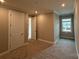 Another view of the carpeted bedroom features two closets and modern trim at 12032 Lavinia Ln, Charlotte, NC 28277