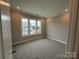 Bright bedroom featuring neutral walls and plush gray carpeting, illuminated by recessed lighting at 12032 Lavinia Ln, Charlotte, NC 28277