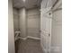 The walk-in closet features carpet, shelving, and a door at 12032 Lavinia Ln, Charlotte, NC 28277
