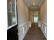 The entryway showcases a long hallway, hardwood floors, and decorative molding, leading into the home at 12032 Lavinia Ln, Charlotte, NC 28277