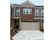 Newly constructed townhome boasts brick facade, attached garage, and welcoming front entrance at 12032 Lavinia Ln, Charlotte, NC 28277