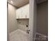 Laundry room includes built-in white cabinets and washer/dryer hookups at 12032 Lavinia Ln, Charlotte, NC 28277