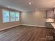 Spacious living room features neutral paint, hardwood floors, and lots of windows at 12032 Lavinia Ln, Charlotte, NC 28277