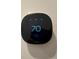 Close-up of smart thermostat, displaying the indoor temperature and energy-saving features at 12032 Lavinia Ln, Charlotte, NC 28277