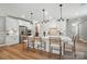 Bright kitchen features a center island with bar stool seating, stainless appliances, and white cabinetry at 12036 Lavinia Ln, Charlotte, NC 28277