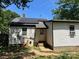 Exterior view of the home's back, featuring solar panels and showing back door at 1212 Meadow Ln, Charlotte, NC 28205