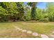 Expansive backyard featuring a stone walkway and lush greenery, perfect for outdoor activities and relaxation at 1233 E Cannon Ave, Albemarle, NC 28001