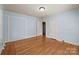 Bright bedroom featuring hardwood floors, fresh paint, and multiple closets at 1233 E Cannon Ave, Albemarle, NC 28001