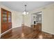 Dining room with hardwood floors, a decorative light fixture, and access to other rooms at 1233 E Cannon Ave, Albemarle, NC 28001