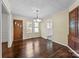 Spacious dining room featuring hardwood floors, natural light, and access to the entryway at 1233 E Cannon Ave, Albemarle, NC 28001