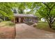 Inviting brick home with a covered porch and a convenient driveway leading up to the residence at 1233 E Cannon Ave, Albemarle, NC 28001