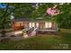 Charming brick home featuring a covered front porch, landscaped yard and walkway leading to the entrance at 1233 E Cannon Ave, Albemarle, NC 28001