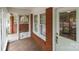 Inviting covered porch with decorative screen door and brick detailing at 1233 E Cannon Ave, Albemarle, NC 28001