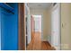 Hallway features hardwood floors, neutral walls, and access to multiple rooms at 1233 E Cannon Ave, Albemarle, NC 28001