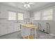 Well-lit kitchen with white cabinets, laminate counters, and a center island with seating at 1233 E Cannon Ave, Albemarle, NC 28001