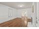 Well-lit living room boasts hardwood floors and white trim and paint at 1233 E Cannon Ave, Albemarle, NC 28001