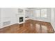 Cozy living room featuring hardwood floors, a fireplace, and built-in bench at 1233 E Cannon Ave, Albemarle, NC 28001