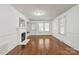 Bright living room with hardwood floors and a classic white fireplace at 1233 E Cannon Ave, Albemarle, NC 28001