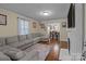 Comfortable living room with hardwood floors, a large sectional sofa, and a fireplace at 1233 E Cannon Ave, Albemarle, NC 28001