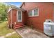 Brick exterior featuring side entrance with small patio at 1233 E Cannon Ave, Albemarle, NC 28001