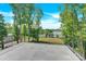 Expansive balcony showcasing scenic views of lush greenery and a tranquil lake at 124 Clipper Ln, Mooresville, NC 28117