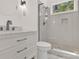 Bright bathroom featuring white vanity with stone countertop and sleek glass shower with herringbone tile at 124 Clipper Ln, Mooresville, NC 28117