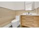 Modern half bathroom with wood paneling, floating vanity with stone countertop, and black hardware at 124 Clipper Ln, Mooresville, NC 28117