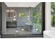 Modern bathroom featuring sleek fixtures, a walk-in shower, and stunning outdoor scenery at 124 Clipper Ln, Mooresville, NC 28117