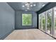 Modern bedroom boasts hardwood floors, gray walls, and plenty of natural light from large windows at 124 Clipper Ln, Mooresville, NC 28117