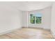 Bright bedroom featuring hardwood floors and a large window overlooking the landscape at 124 Clipper Ln, Mooresville, NC 28117