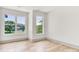 Spacious bedroom featuring hardwood floors and picturesque views through dual windows at 124 Clipper Ln, Mooresville, NC 28117