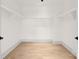 Spacious walk-in closet featuring hardwood floors and a sleek, modern design at 124 Clipper Ln, Mooresville, NC 28117