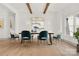 Elegant dining room with stylish chairs, hardwood floors, wood beams, and modern lighting at 124 Clipper Ln, Mooresville, NC 28117