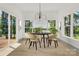 Bright dining area with views, hardwood floors, a modern chandelier, and elegant furniture at 124 Clipper Ln, Mooresville, NC 28117