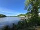Beautiful lake view showcasing a covered dock, perfect for enjoying waterfront living and recreational activities at 124 Clipper Ln, Mooresville, NC 28117