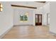 Spacious entryway featuring hardwood floors, wood beams, large windows, and elegant lighting at 124 Clipper Ln, Mooresville, NC 28117