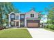 Beautiful modern home with a two-car garage and well-manicured lawn and professional landscaping at 124 Clipper Ln, Mooresville, NC 28117