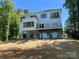 Modern home exterior featuring multiple balconies, large windows, and a stylish design on a well-maintained lot at 124 Clipper Ln, Mooresville, NC 28117