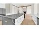 Open-concept kitchen with an island, hardwood floors, and modern appliances flowing into the adjacent living area at 124 Clipper Ln, Mooresville, NC 28117