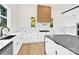 Bright and modern kitchen featuring white cabinetry, a stylish backsplash, and a spacious layout for cooking and entertaining at 124 Clipper Ln, Mooresville, NC 28117