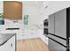 Modern kitchen featuring stainless steel appliances, a marble backsplash, and elegant countertops, offering a luxurious cooking space at 124 Clipper Ln, Mooresville, NC 28117