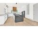 Sleek kitchen featuring a large center island, modern cabinetry, stainless steel appliances, and hardwood flooring at 124 Clipper Ln, Mooresville, NC 28117