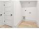 Laundry room with white walls, bright hard wood floors and convenient hookups at 124 Clipper Ln, Mooresville, NC 28117