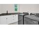 Well-equipped laundry room with modern appliances and stylish tile flooring at 124 Clipper Ln, Mooresville, NC 28117