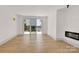 Spacious living room with a fireplace, lake views, and light hardwood floors throughout at 124 Clipper Ln, Mooresville, NC 28117