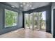 Inviting living room featuring expansive windows and folding doors offering panoramic views at 124 Clipper Ln, Mooresville, NC 28117